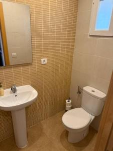 a bathroom with a white toilet and a sink at Exclusivo Adosado Jalance in Jalance +7 photos