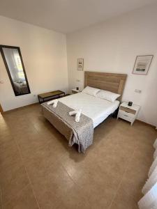 a bedroom with a bed and a bench in it at Exclusivo Adosado Jalance in Jalance