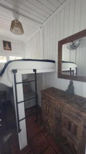 a room with a bunk bed and a mirror at Casa Feia Hostel in Costa da Caparica +49 photos