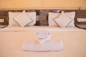 a bed with a white towel on top of it at Rumis Desert Camp in Jaisalmer +78 photos
