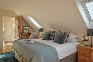 a bedroom with a large white bed with pillows at Meadow View House at Pudleston Court in Docklow +14 photos