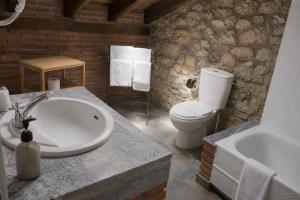 a bathroom with a sink and a toilet and a tub at Posada La Llosa de Viveda - Adults Only in Santillana del Mar +46 photos