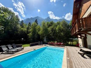 a swimming pool with a view of mountains at Chalet Les Ecrins in Vénosc