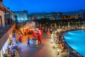 a group of people standing on a balcony next to a pool at World Star Beach Resort & Spa in Alanya +170 photos