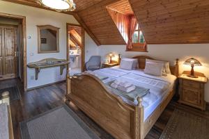 a bedroom with a large bed in a room at Hanga Vendégház Parád in Parád