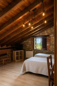 a bedroom with a large bed in a stone building at Posada La Llosa de Viveda - Adults Only in Santillana del Mar