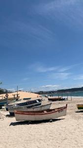 a group of boats sitting on a sandy beach at HOTEL MORADA DO SOL in Pontal do Paraná
