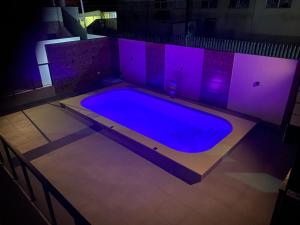 a large swimming pool with purple lights in a room at HOTEL MORADA DO SOL in Pontal do Paraná +38 photos