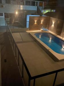 a large swimming pool in a building with lights at HOTEL MORADA DO SOL in Pontal do Paraná