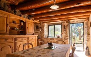 a kitchen with a table and chairs and a window at L'echappée de la lozère in Les Laubies