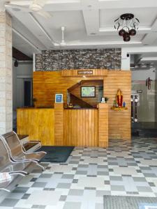 a lobby with chairs and a counter in a building at Annai Ocean Park in Velankanni