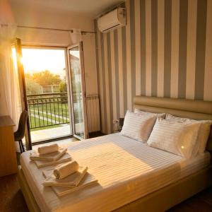 a bedroom with a bed with two towels on it at Vila CarpeDiem in Herceg-Novi +26 photos