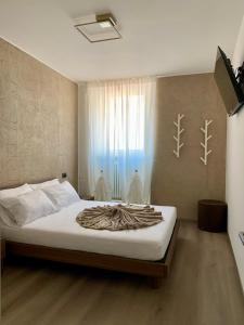a bedroom with a bed with a blanket on it at San Rocco Apartments 2 in Riva del Garda