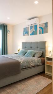 a bedroom with a large bed with a white wall at Vila Atlantida in Velika