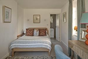 a bedroom with a bed with pillows on it at Red Gables at Pudleston Court in Docklow +18 photos