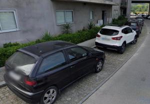 two cars parked in a parking lot next to a building at flat4u in Paredes