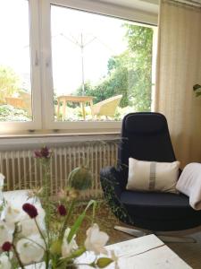 a living room with a chair and a window at Ferien am See in Möhnesee