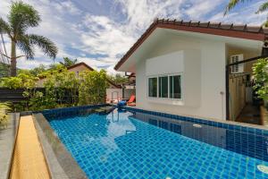 a swimming pool in front of a villa at Chalong - 2 Bedroom Hideaway Private Pool Villa - Phuket in Chalong +21 photos