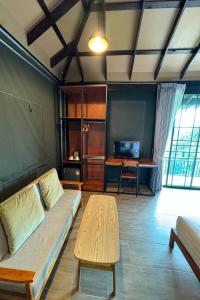 a living room with a couch and a table at Pha Lae Tawan@Siray in Phuket