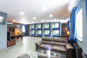 a living room with a couch and a desk at Hostel IRON CUBE in Stružná