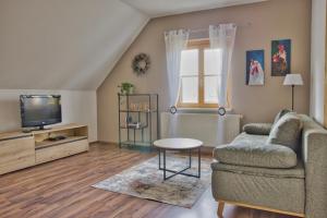 a living room with a couch and a tv at Bauernhof Kure in Leutschach