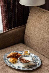 a tray with a plate of food on a chair at Hôtel Marais Hôme in Paris +87 photos