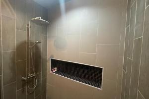 a bathroom with a shower with a grate in it at Pha Lae Tawan@Siray in Phuket +33 photos