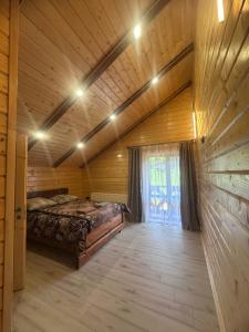 a bedroom with a bed in a wooden room at Сузірʼя in Vorokhta
