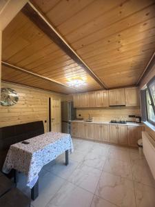 a kitchen with a table in the middle of a room at Сузірʼя in Vorokhta