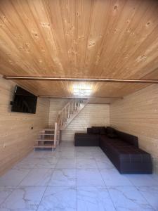 a room with a couch and a wooden ceiling at Сузірʼя in Vorokhta