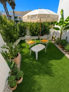 a patio with two chairs and an umbrella at B&B L'ORIZZONTE in Crotone