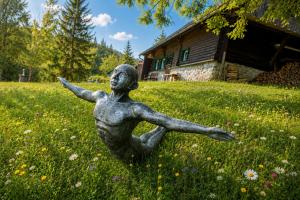 a statue of a boy in a field of grass at Frein Chalets - Kaltenbach 1A in Frein