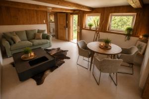 a living room with a couch and a table at Frein Chalets - Kaltenbach 1A in Frein