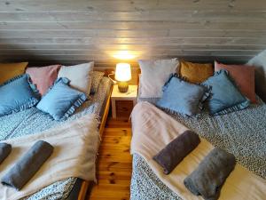two beds with pillows on them in a room at GÓRSKA SIELANKA in Istebna +38 photos