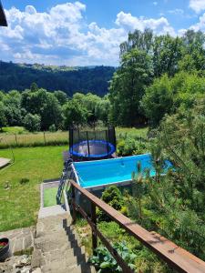 a swimming pool in a field with trees at GÓRSKA SIELANKA in Istebna