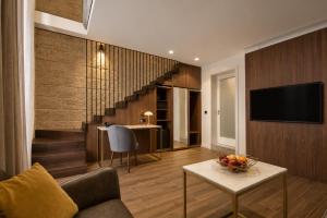 a living room with a couch and a television at 23 Boutique Hotel in Il-Furjana
