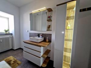 a bathroom with a sink and a mirror at Henneberger Hof Goldstück in Münnerstadt +17 photos