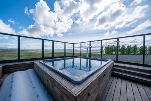 a hot tub on the deck of a house at Hotel Stafholt in Varmaland