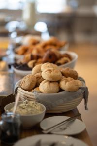 a table topped with bowls of dips and plates of food at Hotel Stafholt in Varmaland