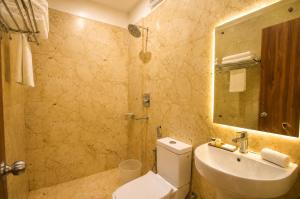 a bathroom with a toilet and a sink and a mirror at Namastey Puri Hotel - Near Jagannath Dham Temple With Restaurant And Parking Facility Fully Air Conditioning Room in Puri