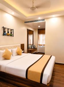 a bedroom with a large bed in a room at Namastey Puri Hotel - Near Jagannath Dham Temple With Restaurant And Parking Facility Fully Air Conditioning Room in Puri