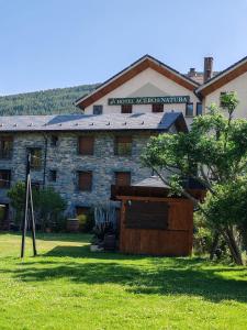 an exterior view of a building in a field at Hotel Acebo & Natura in Castiello de Jaca