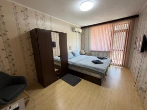 a small room with a bed and a mirror at Izgrev Sarafovo in Burgas +44 photos