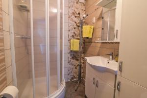 a bathroom with a shower and a sink at Počitniško stanovanje Aurora in Bovec +17 photos