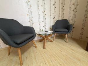 two chairs and a coffee table in a room at Izgrev Sarafovo in Burgas