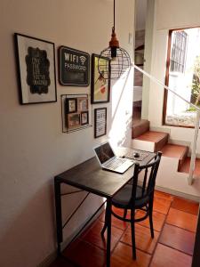 a room with a table with a laptop on it at Viento Azul Guest House in Punta del Este