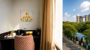 a hotel room with a desk and a window at BluO Lake View NewTown - Boutique Hotel in Kolkata