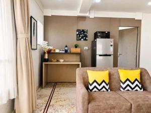 a living room with a couch and a kitchen at BluO Lake View NewTown - Boutique Hotel in Kolkata