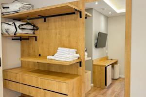 a room with wooden shelves with towels and a television at Zena Hotel Durres in Durrës +99 photos