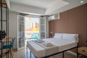 a bedroom with a bed with towels on it at Ella Torremolinos Centro in Torremolinos +66 photos